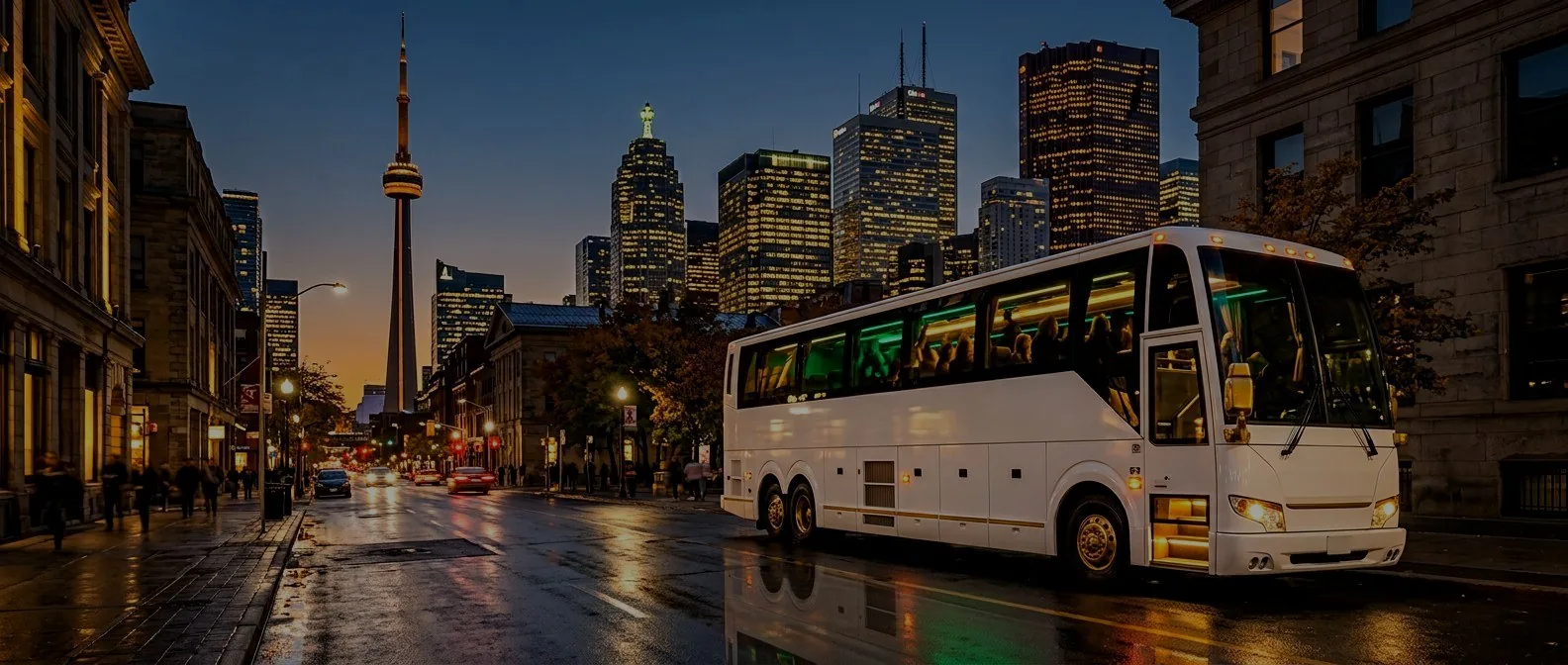 Luxury white party bus with emerald LED interior on a Toronto street at dusk, CN Tower skyline in the background